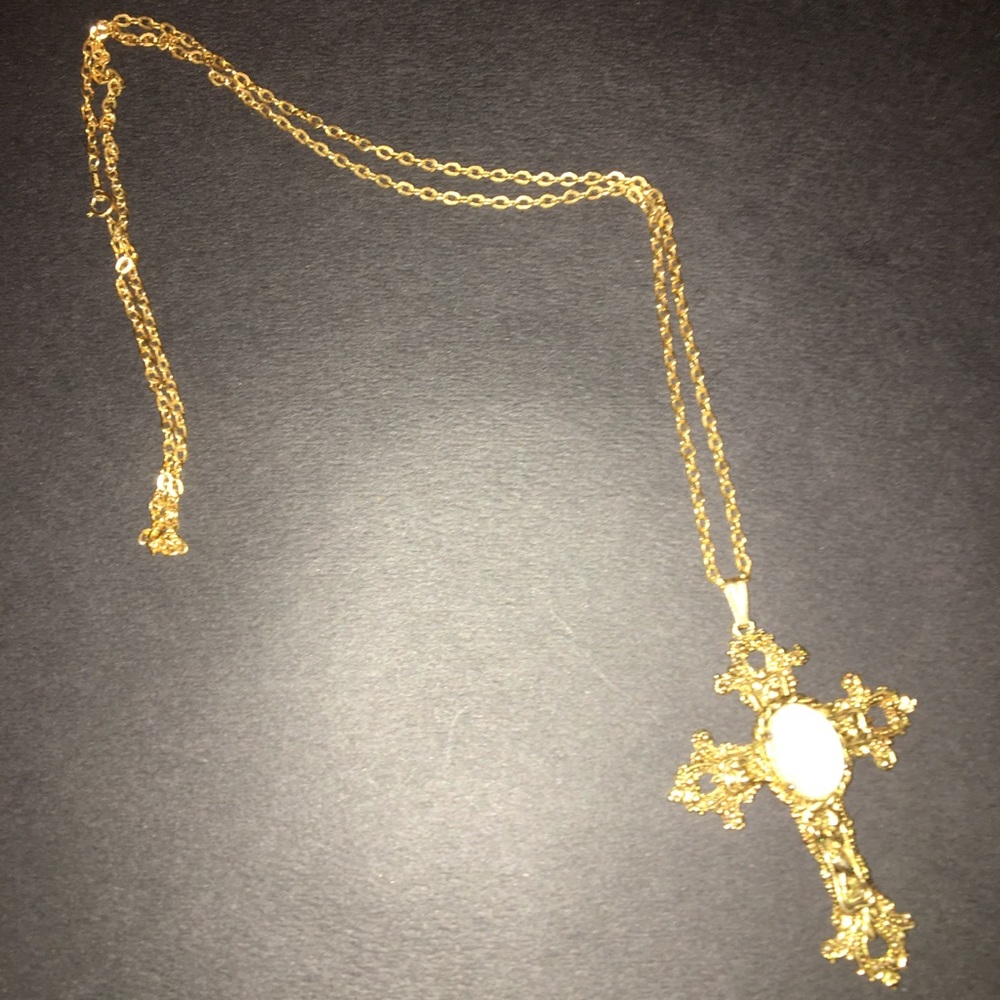 Costume gold cross with opal like stone.